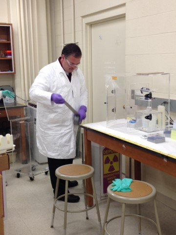 A radiation worker working with radiation in a lab.