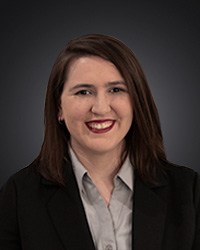 a woman with black blazer posing for a headshot