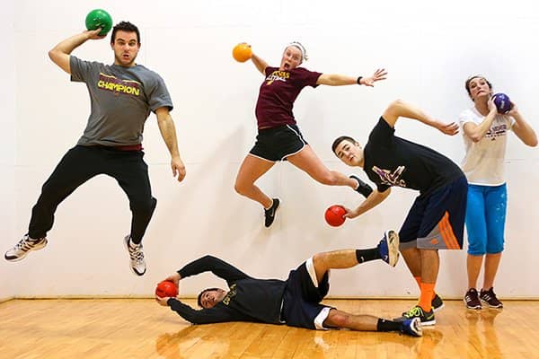 Intramural-Champions-600x400 5 students in athletic wear with sports balls in their hands, jumping and playing.