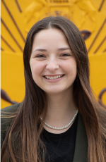 Headshot of Supplemental Instructor leader Ashylyn LaPratt standing in front of the gold cmu seal.