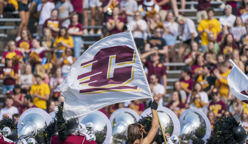 A white flag with an Action C amongst the marching band at a CMU Football game.