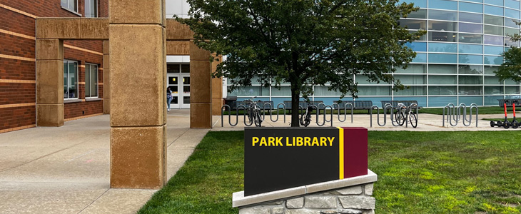 Still image of the Park Library south entrance featuring the Park Library wayfinding sign.