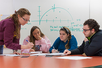 Students working, collaborating in the group study room at the Central Michigan University - University Libraries - Park Library