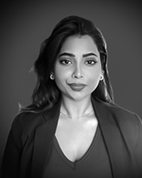 Black and white image of Angali Gujjar, a woman, looking at the camera.