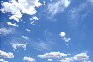 A JPEG image of a blue sky with white clouds