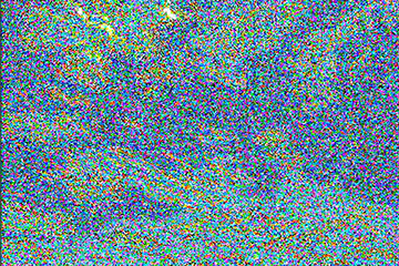 A JPEG image of a blue sky with clouds on top after being saved 600 times, illustrating the quality loss and heavy pixelation.