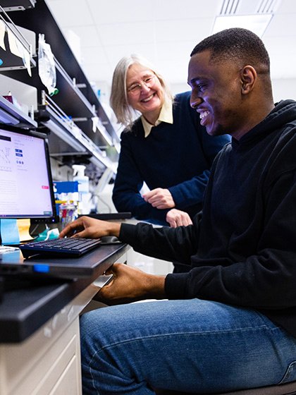 Faculty member and student from the College of Medicine conducting research on a computer.