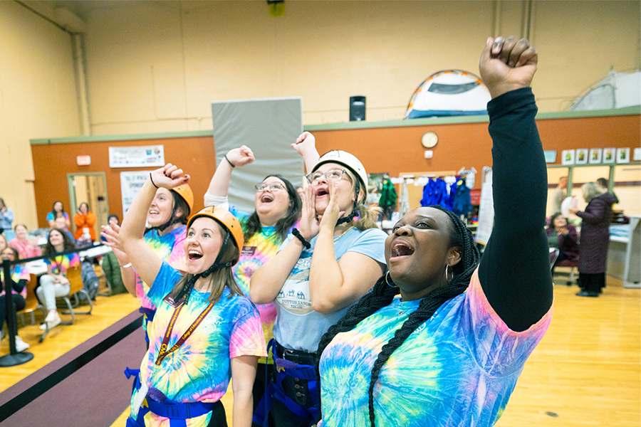 Group of girls cheering on a rock climber at CMU's Adventure Seminar.