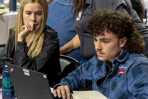 Students concentrate on laptop during ERPsim.