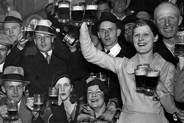 Men and women celebrate "New Beer's Eve" with mugs of beer on April 6, 1933.