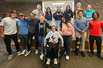 Members of the Diversity, Equity and Inclusion Mentorship program stand together in the College of Business Administration.