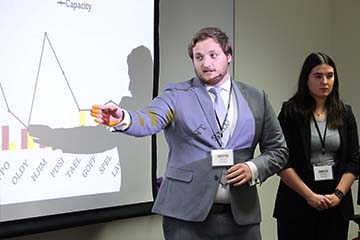 Two students presenting at the 4th annual Logistics Annual Case Competition.