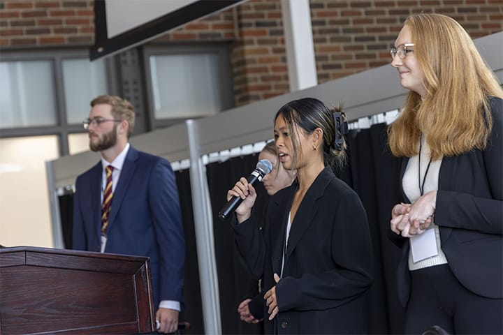 CMU students presenting their case study in the Grawn Atrium during the Logistics Management Case Competition.