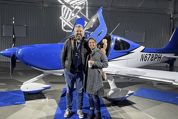 Stephen Wakeling and Erin Gendron in front of an airplane.
