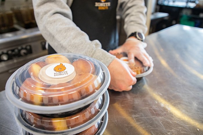 Three packages full of donuts from the Ignite Donuts bakery.