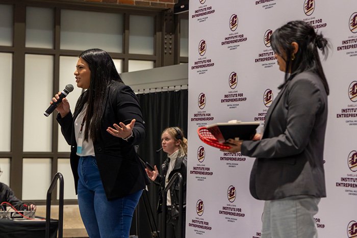 Two students pitching their idea on stage during the 2023 Make-A-Pitch competition.