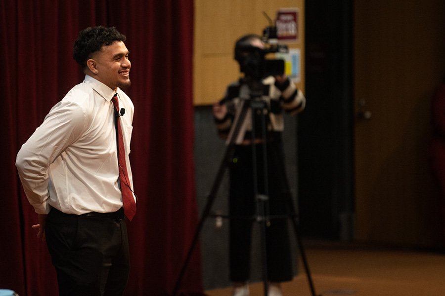 A student standing in French Auditorium presenting his venture idea.