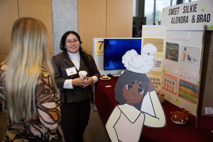 A student presenting her animation project at the New Venture Challenge.