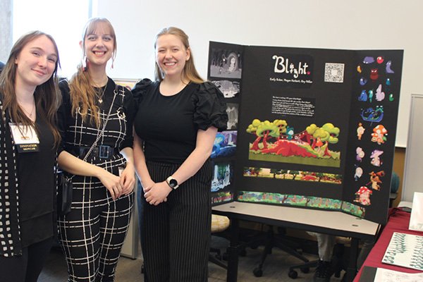 Three animation students presenting their Innovation Showcase project Blight at the 2024 New Venture Challenge.