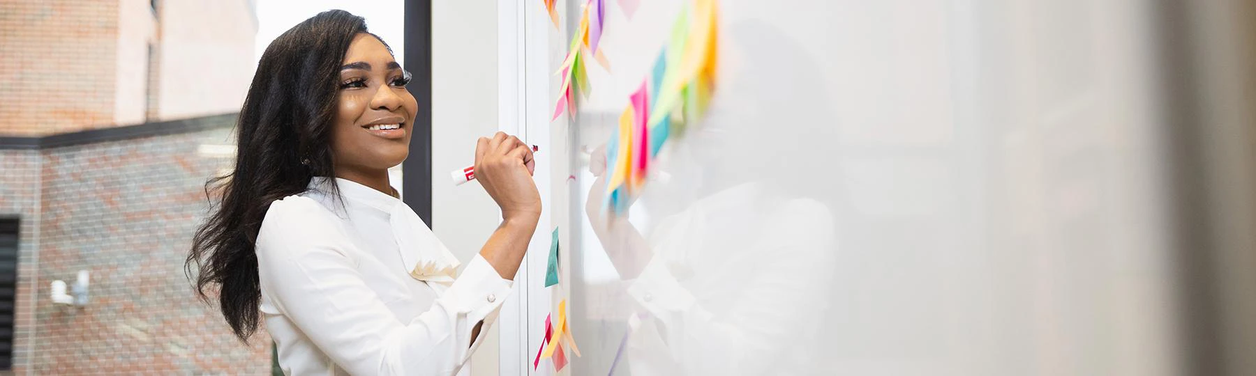 A person writing on a white board