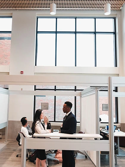 a group of people sitting at a desk