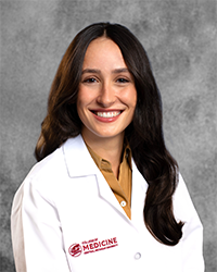 Pelak, Helen 200x250 A female CMU College of Medicine medical student wearing her white coat as she smiles for the camera.