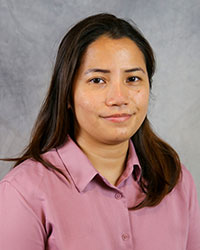 Headshot of Ana Camagay wearing a rose colored dress shirt.