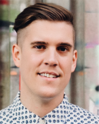 Headshot of Jeremiah Britton in front of a store window.