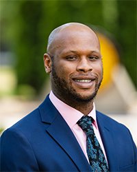 Headshot of Danny McQuarters Jr. with the CMU seal in the background.