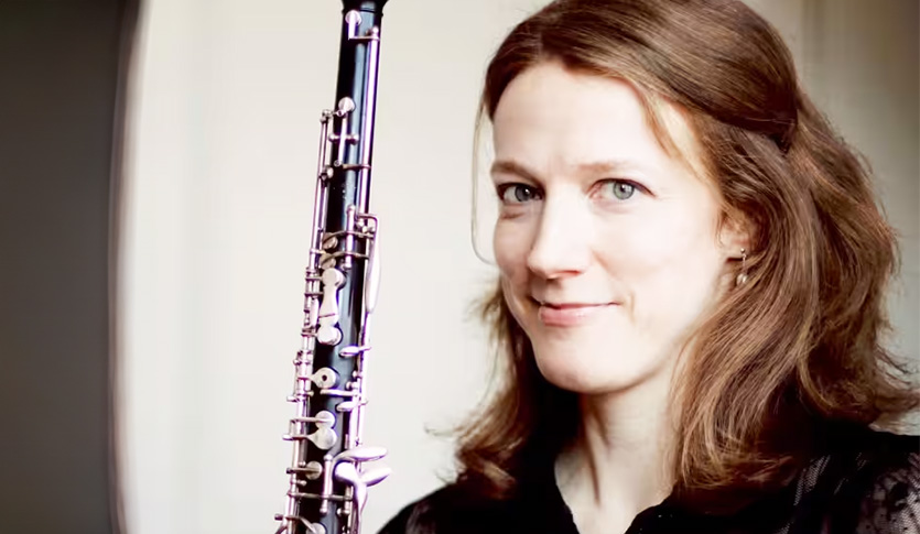 A close-up picture of Monica Fosnaugh holding an oboe.