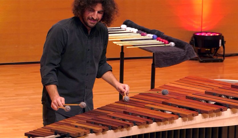 A picture of Dr. Marco Schirripa in black attire playing marimba at Staples Family Concert Hall.