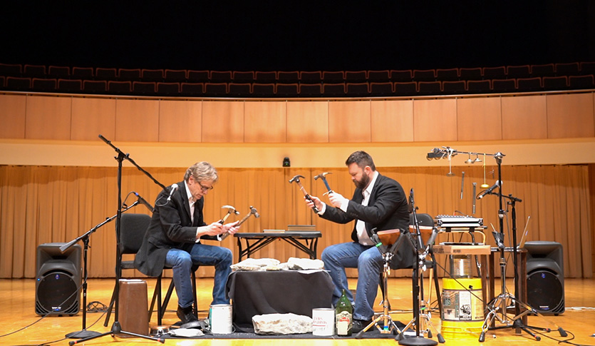 The percussion group The Innocents performs a piece in a theater.