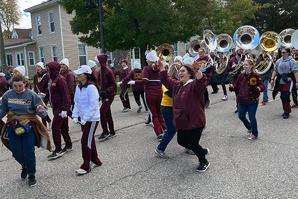 A picture of members of the 2022 CMU Alumni Band marching on the street.