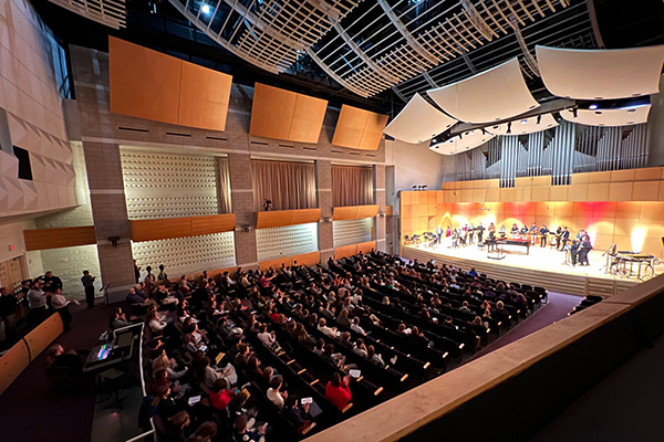 A picture of an audience and a music ensemble performing at Staples Family Concert Hall.