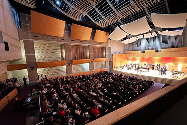 A picture of an audience and a music ensemble performing at Staples Family Concert Hall.