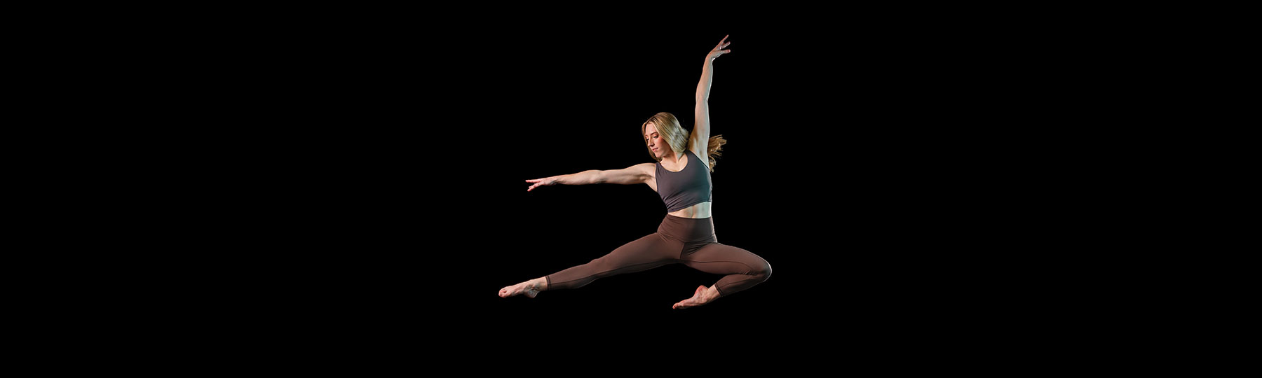 Image of a dancer mid-air on stage.