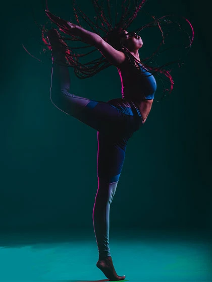 image of a dance posing with blue back lighting.