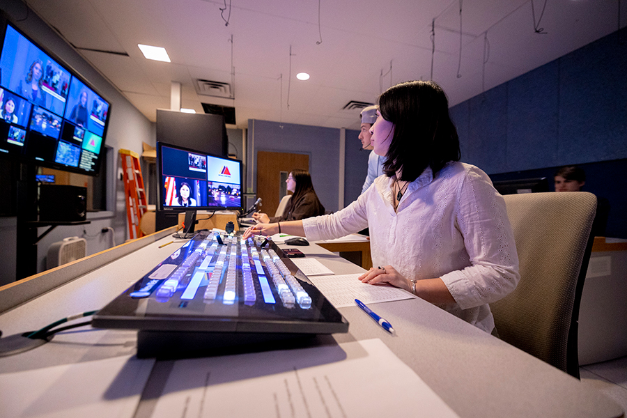 Student working in a broadcast control room.