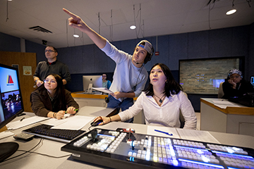 Megan Hart working in the TV station studio along side some of her classmates.