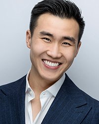 Headshot of Brandon Chu on a soft grey backdrop.