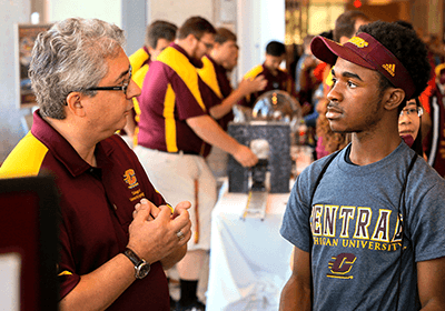 faculty member talking with a student