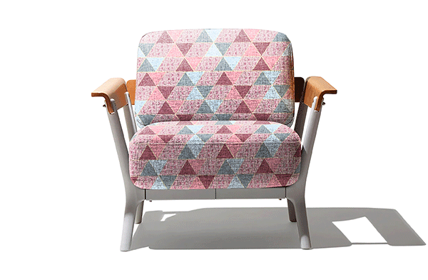 Computer image if upholstered chair with pink and blue triangle pattern