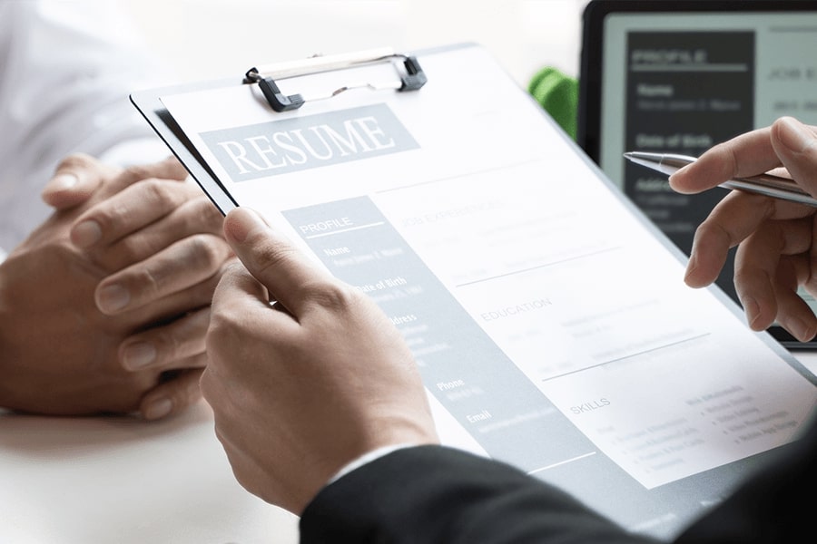 close up of hands and holding a resume