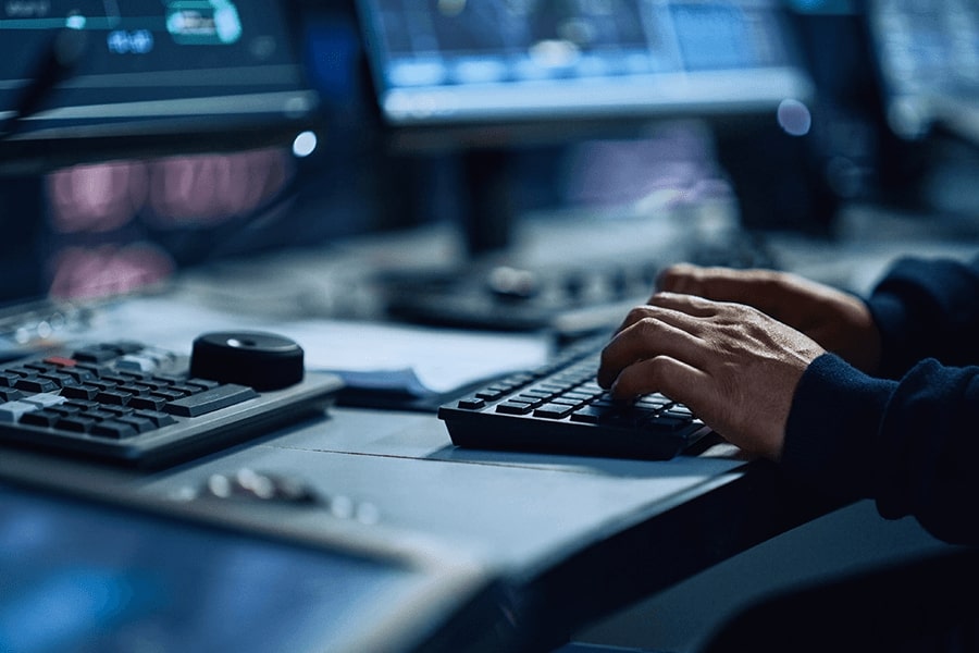 hands typing on a computer keyboard