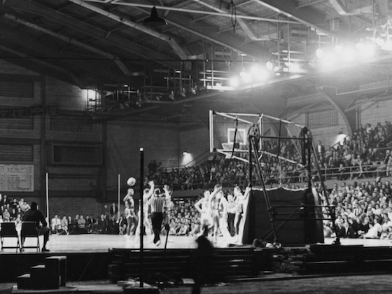 A historic black and white photo of a CMU basketball game taking place inside Finch Fieldhouse.