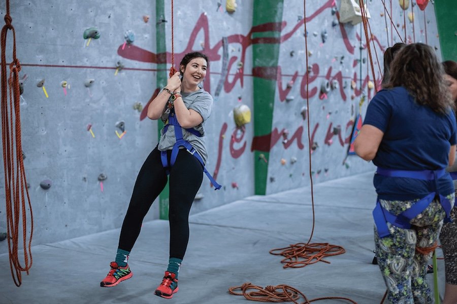 Student using the rock climbing wall in Finch Fieldhouse.