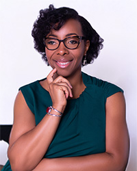 Closeup image of Kidada Williams wearing glasses and a green shirt.