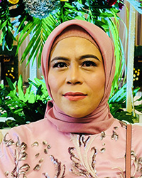 Closeup image of Hasnul Insani wearing a pink shirt and hijab.