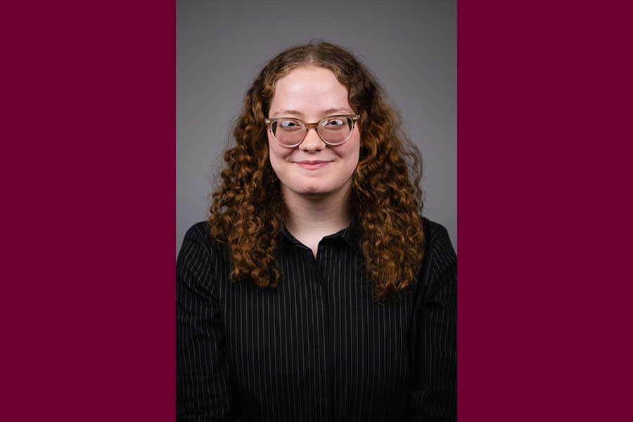 a woman with curly hair wearing glasses