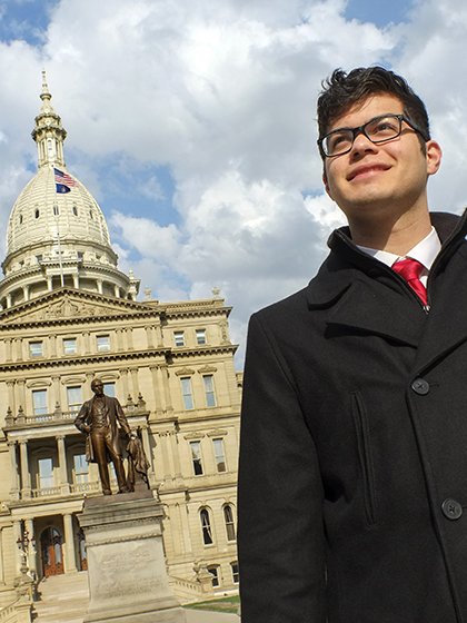 Central Michigan University political science student in front of the capitol building in Lansing